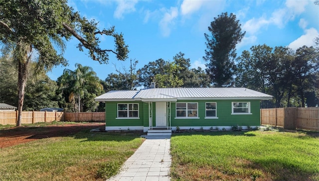 ranch-style home with a front lawn