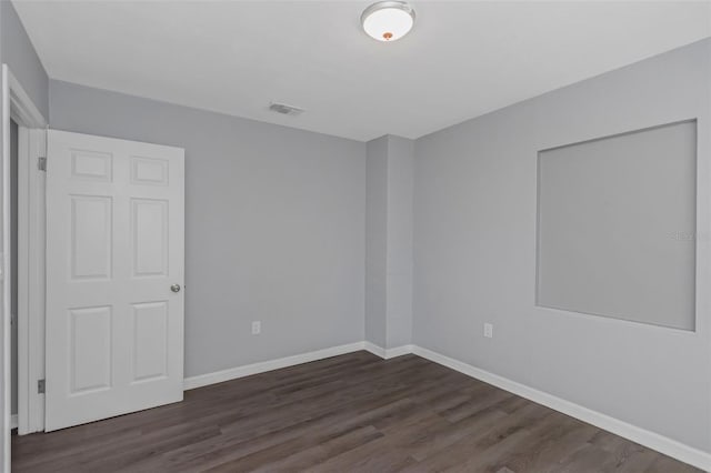 spare room with dark hardwood / wood-style floors