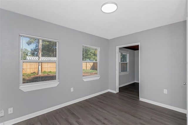 empty room with dark hardwood / wood-style floors