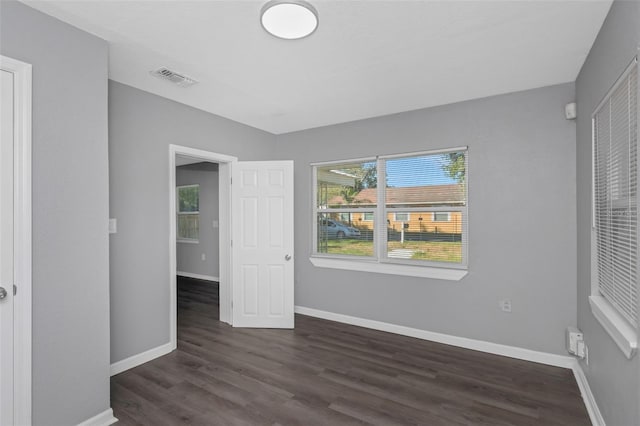 unfurnished bedroom with dark wood-type flooring