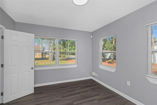 unfurnished room featuring dark hardwood / wood-style floors