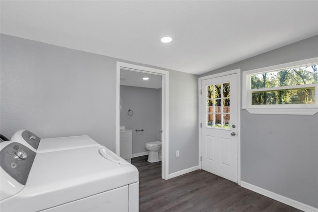 laundry room with dark hardwood / wood-style floors and washer and dryer