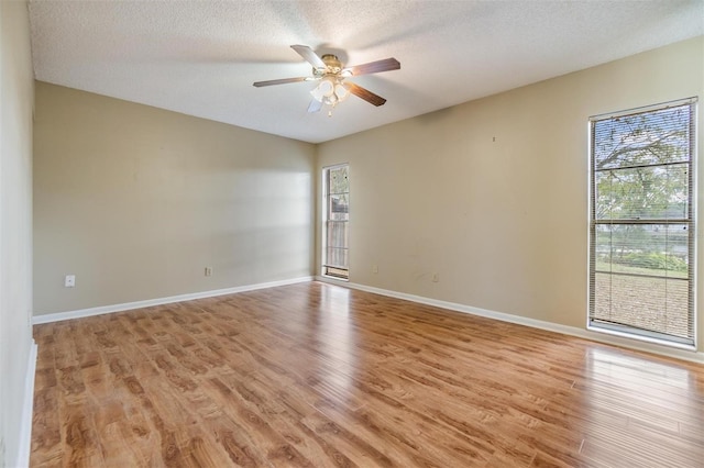 spare room featuring ceiling fan, a textured ceiling, and light wood-type flooring