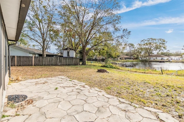 view of yard with a water view and a patio area