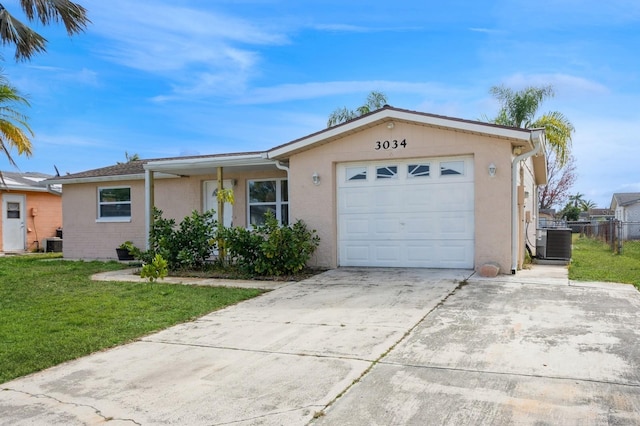 single story home with a garage, a front yard, and central air condition unit