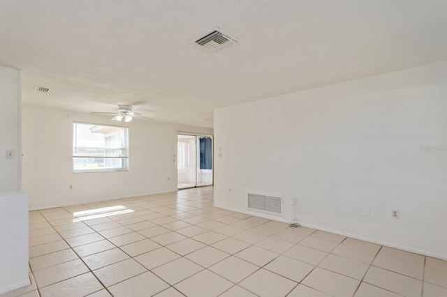 tiled spare room featuring ceiling fan