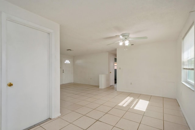 unfurnished room with light tile patterned flooring and ceiling fan