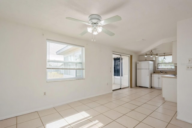 interior space featuring ceiling fan and vaulted ceiling