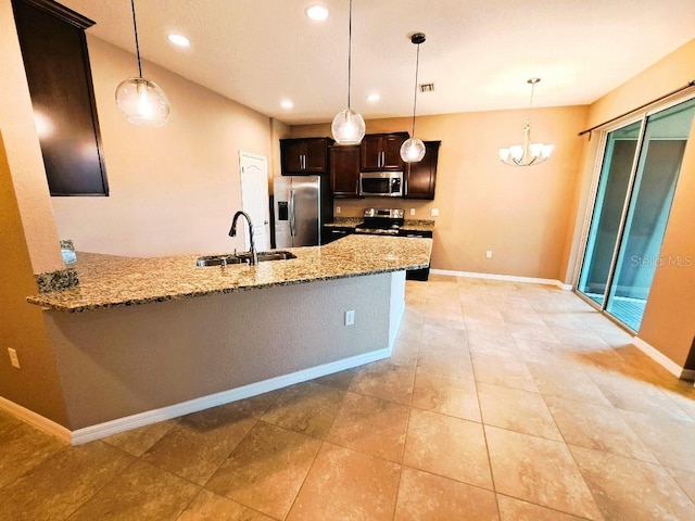 kitchen with sink, decorative light fixtures, kitchen peninsula, and appliances with stainless steel finishes