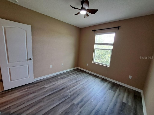 spare room with ceiling fan and wood-type flooring