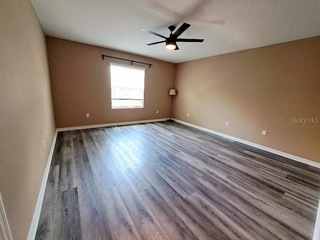 empty room with hardwood / wood-style floors and ceiling fan