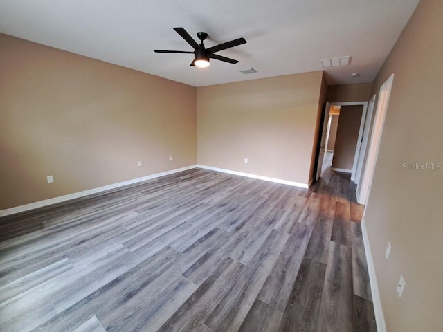 spare room featuring hardwood / wood-style flooring and ceiling fan