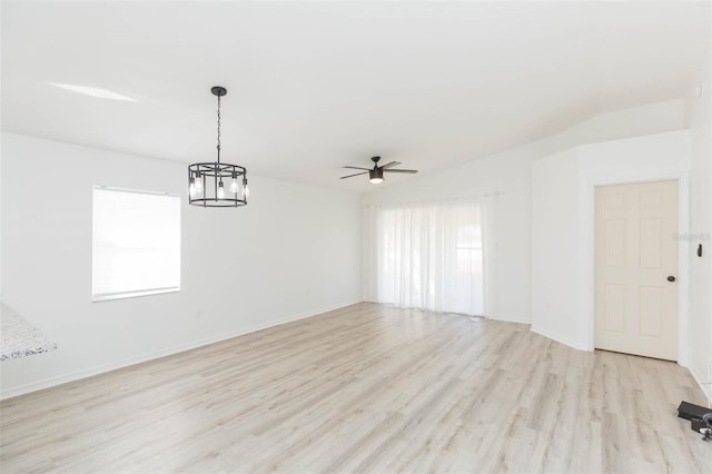 empty room with ceiling fan, lofted ceiling, and light wood-type flooring