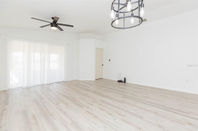 interior space with lofted ceiling, ceiling fan with notable chandelier, and light hardwood / wood-style flooring