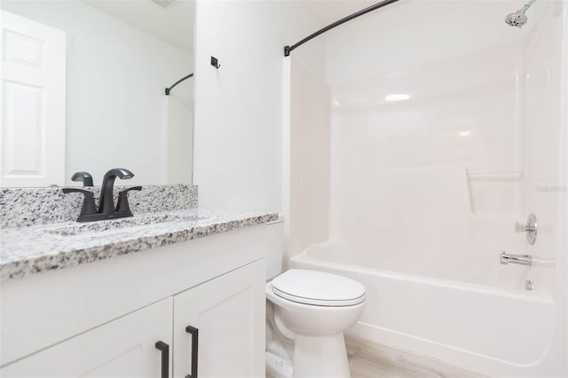 full bathroom featuring vanity, bathtub / shower combination, hardwood / wood-style floors, and toilet