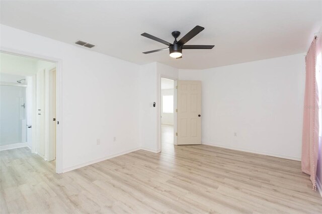 empty room featuring ceiling fan and light hardwood / wood-style flooring