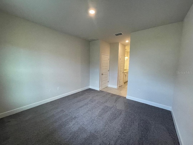 empty room with light colored carpet