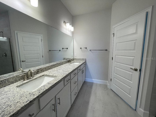 bathroom with vanity and a shower with door