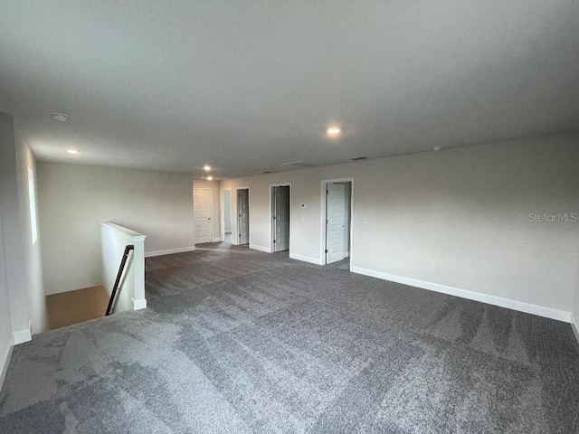 empty room with dark colored carpet