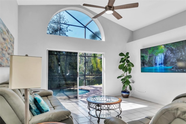 tiled living room featuring ceiling fan and high vaulted ceiling