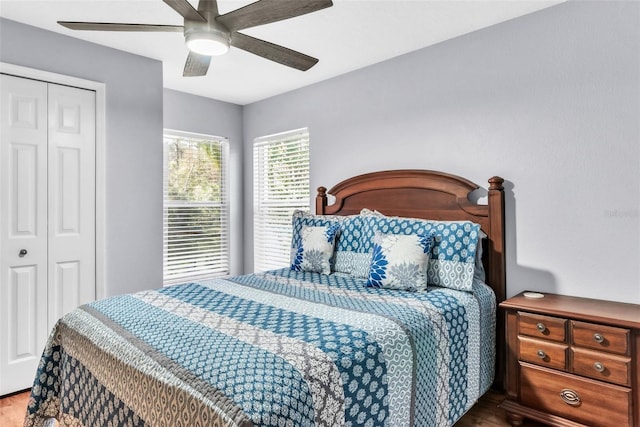 bedroom with ceiling fan, wood-type flooring, and a closet