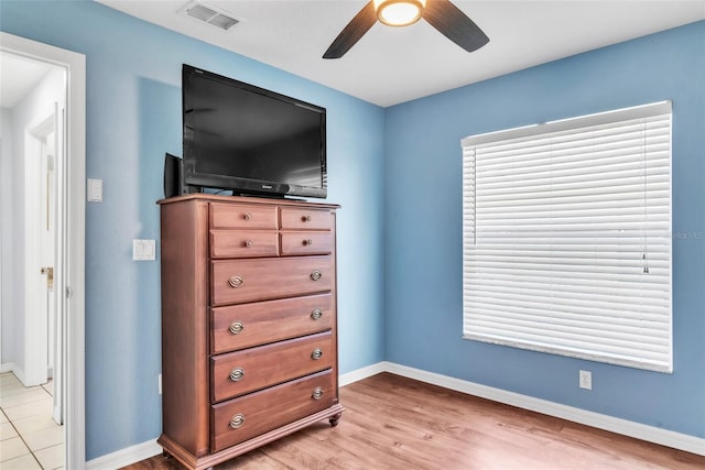 bedroom with light hardwood / wood-style flooring and ceiling fan