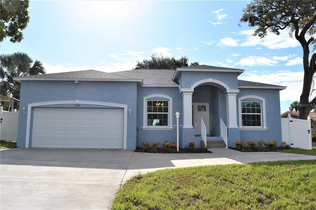 view of front facade featuring a garage and a front lawn