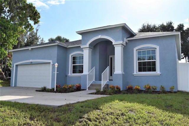 single story home with a garage and a front yard