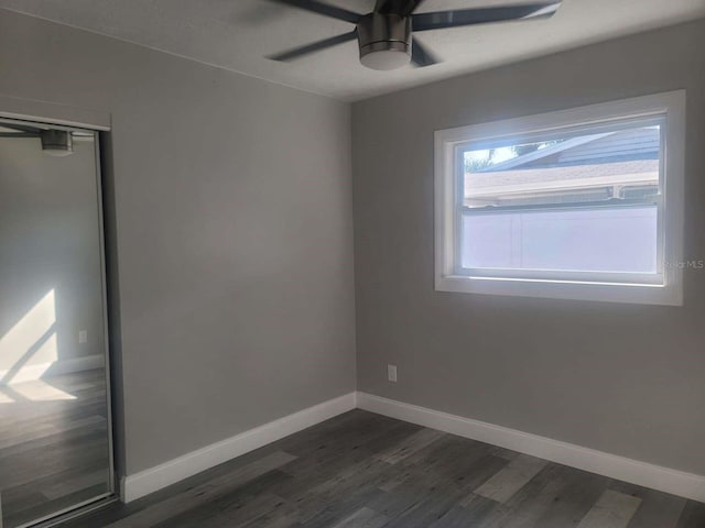 spare room with ceiling fan and dark hardwood / wood-style floors