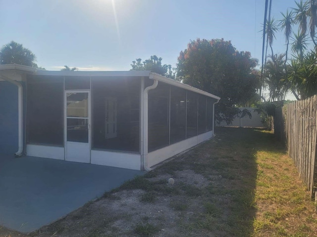 view of side of home with a sunroom