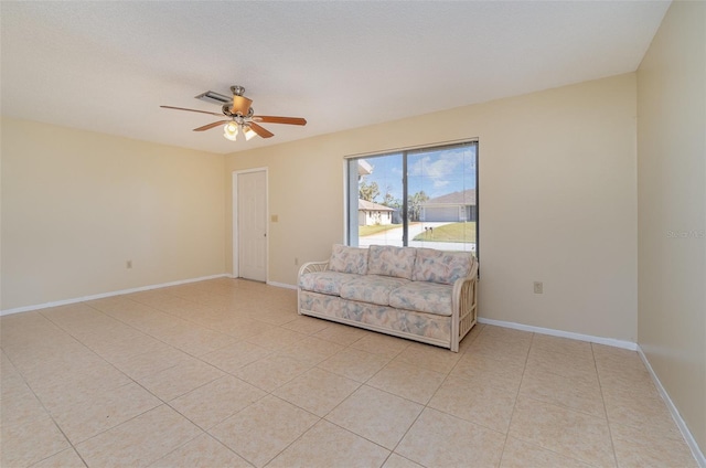 living area featuring light tile patterned floors and ceiling fan