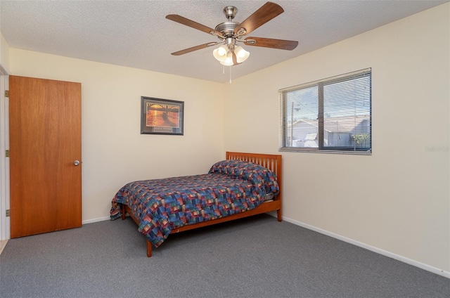 carpeted bedroom with a textured ceiling and ceiling fan