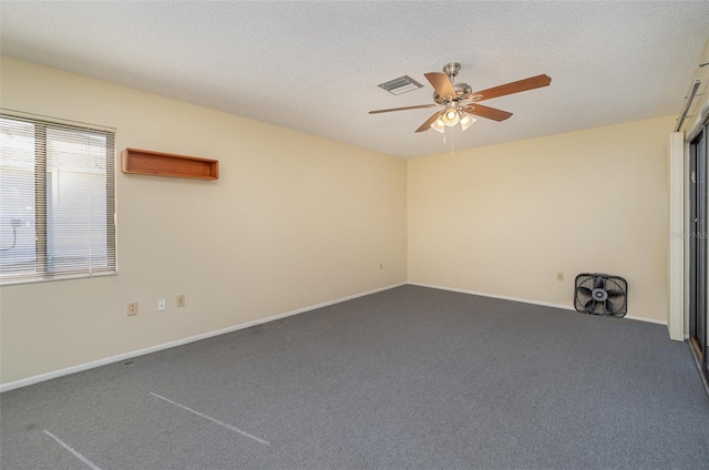 carpeted spare room with ceiling fan and a textured ceiling