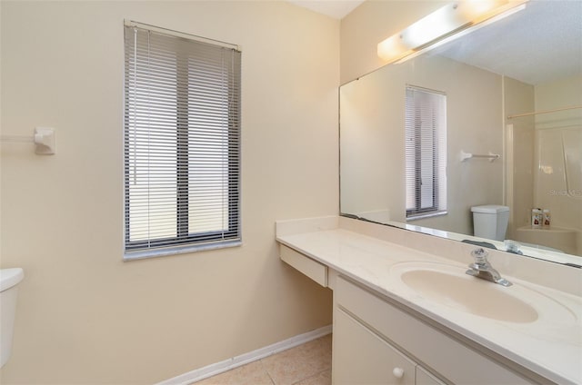 bathroom with a shower, vanity, tile patterned floors, and toilet