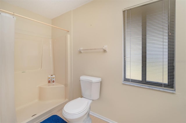 bathroom with toilet, a textured ceiling, and walk in shower