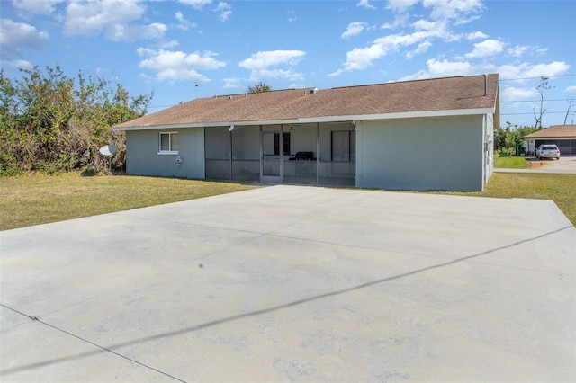 back of property featuring a yard