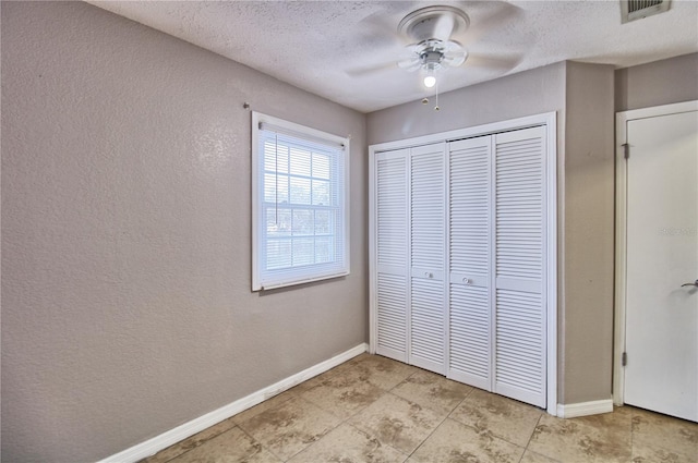 13760 Orange Sunset Dr Unit 201, Tampa, FL 33618 - unfurnished bedroom with ceiling fan, a textured ceiling, and a closet