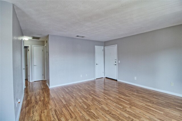 13760 Orange Sunset Dr Unit 201, Tampa, FL 33618 - empty room featuring hardwood / wood-style floors and a textured ceiling