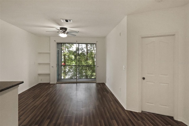 spare room with dark hardwood / wood-style flooring and ceiling fan