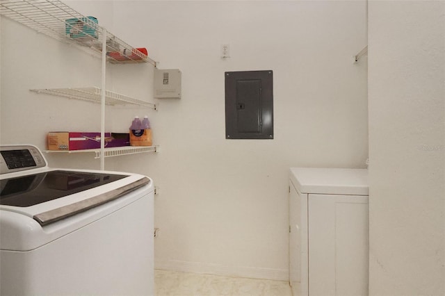 clothes washing area featuring electric panel and washing machine and dryer