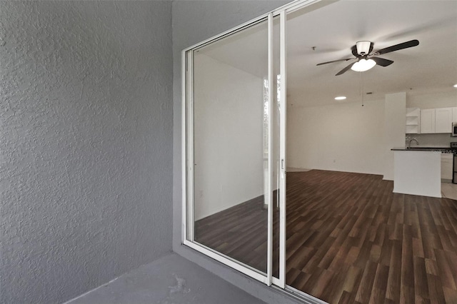 interior space with ceiling fan