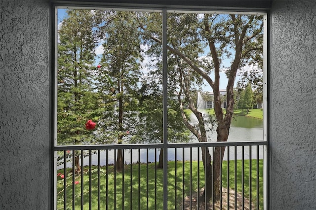 unfurnished sunroom featuring a water view