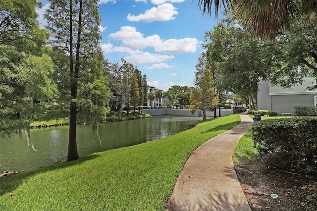 view of community featuring a water view and a lawn