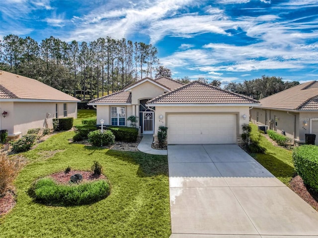 view of front of property with a garage and a front lawn