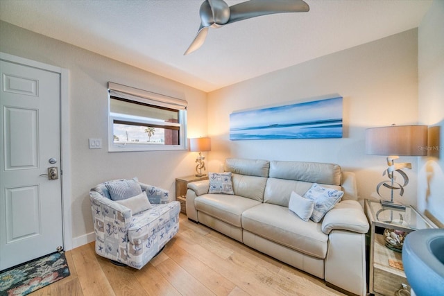 living room featuring ceiling fan and light wood-type flooring