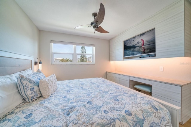 bedroom with built in desk and ceiling fan