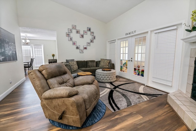 living room featuring a notable chandelier, hardwood / wood-style flooring, and french doors