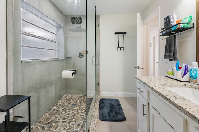 bathroom featuring vanity, tile patterned floors, and walk in shower