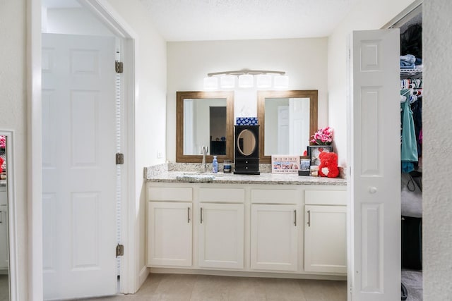 bathroom with vanity and tile patterned floors