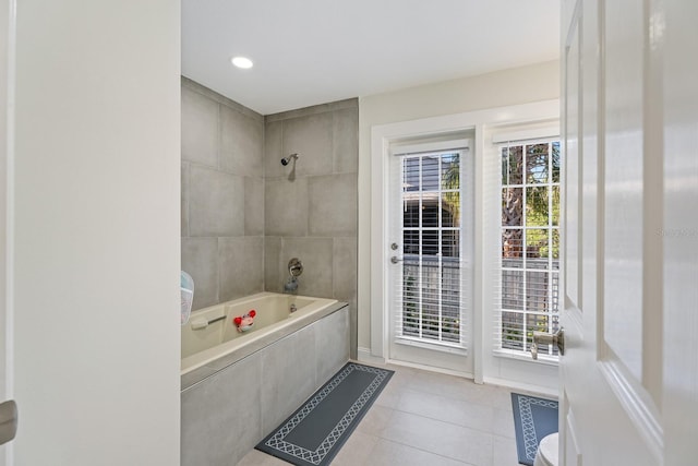 bathroom featuring tile patterned flooring and tiled shower / bath combo